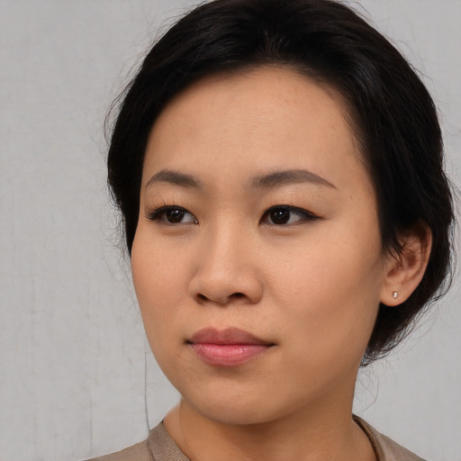 Joyful asian young-adult female with medium  black hair and brown eyes
