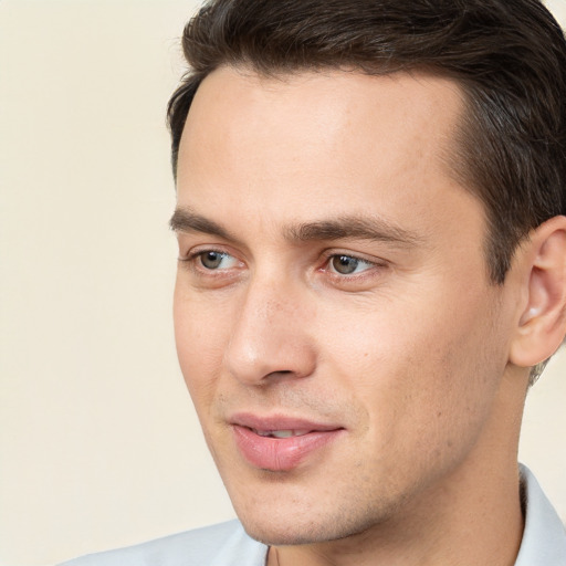 Joyful white young-adult male with short  brown hair and brown eyes