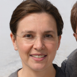 Joyful white adult female with short  brown hair and grey eyes