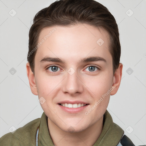 Joyful white young-adult male with short  brown hair and grey eyes