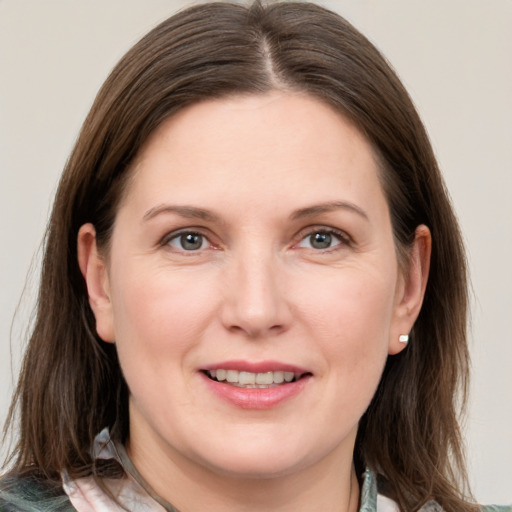 Joyful white adult female with medium  brown hair and grey eyes