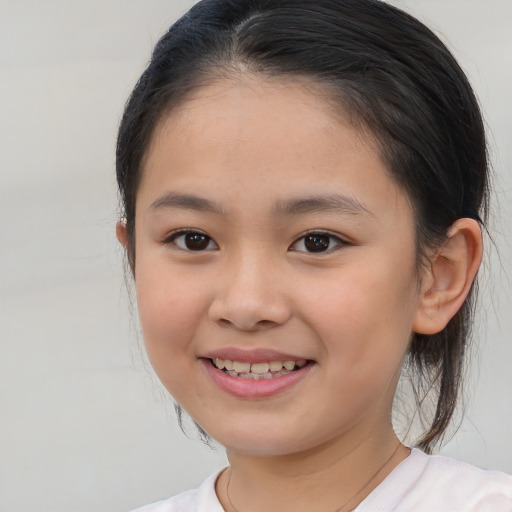 Joyful white child female with medium  brown hair and brown eyes