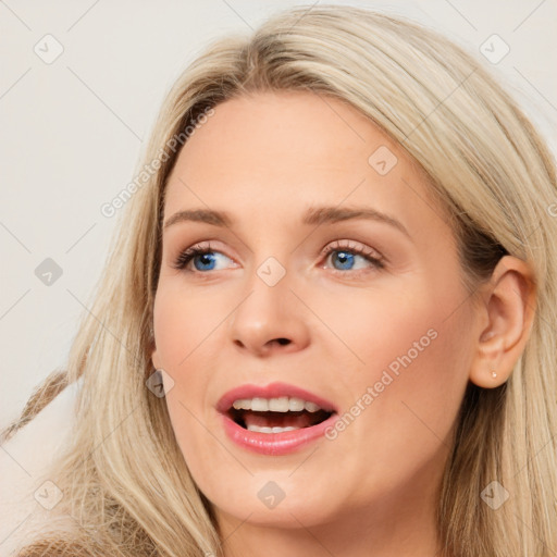 Joyful white young-adult female with long  brown hair and blue eyes