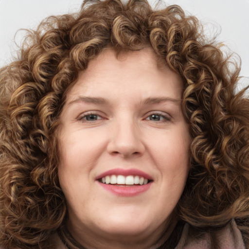 Joyful white young-adult female with long  brown hair and green eyes