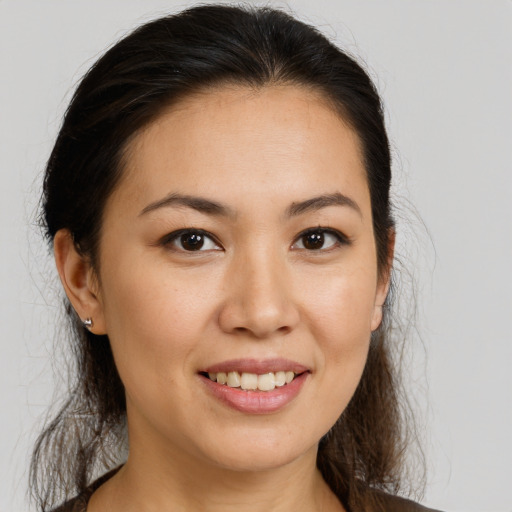 Joyful white young-adult female with long  brown hair and brown eyes