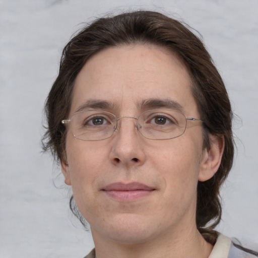 Joyful white adult male with medium  brown hair and brown eyes