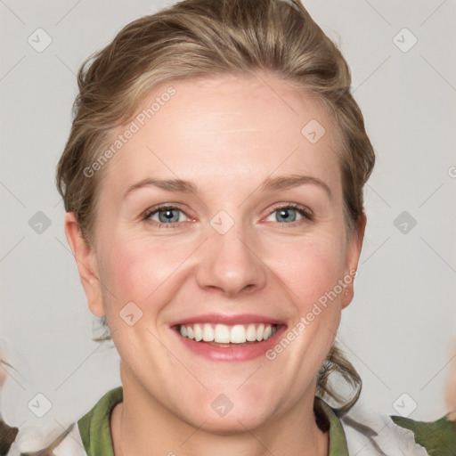 Joyful white adult female with medium  brown hair and grey eyes