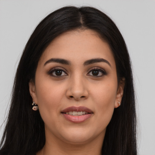 Joyful latino young-adult female with long  brown hair and brown eyes