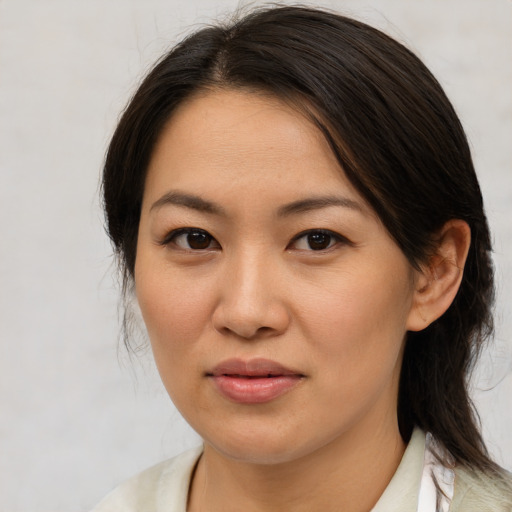 Joyful asian young-adult female with medium  brown hair and brown eyes