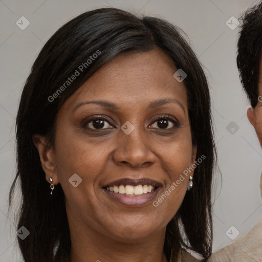 Joyful black adult female with long  brown hair and brown eyes