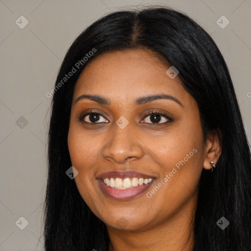 Joyful black young-adult female with long  black hair and brown eyes