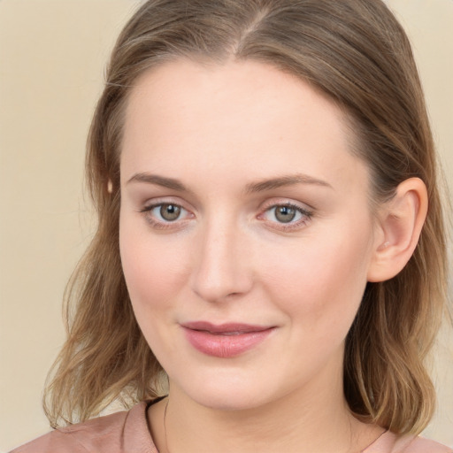 Joyful white young-adult female with medium  brown hair and blue eyes