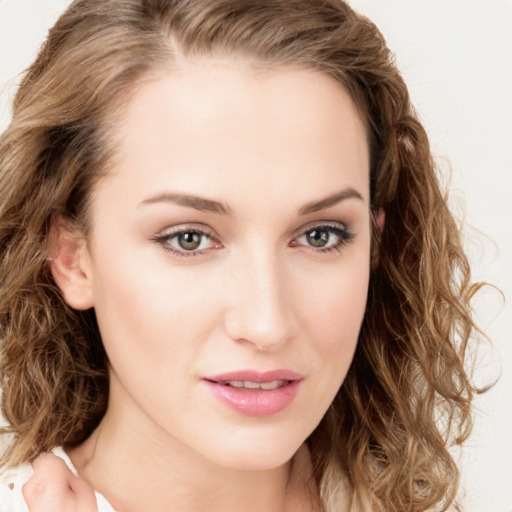 Joyful white young-adult female with long  brown hair and green eyes