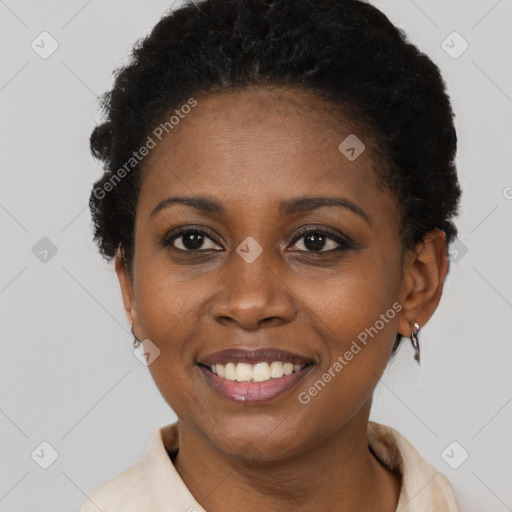 Joyful black young-adult female with short  black hair and brown eyes