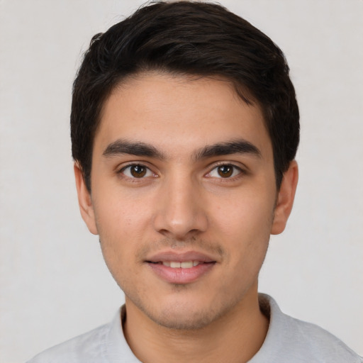 Joyful white young-adult male with short  black hair and brown eyes