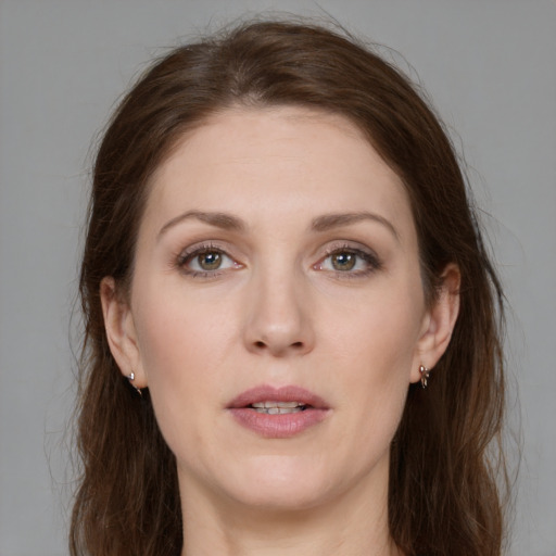 Joyful white young-adult female with long  brown hair and grey eyes