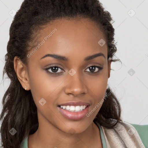 Joyful black young-adult female with long  brown hair and brown eyes