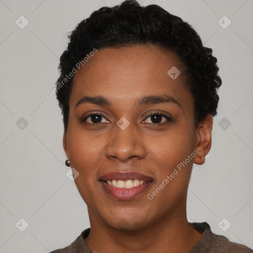 Joyful black young-adult female with short  black hair and brown eyes