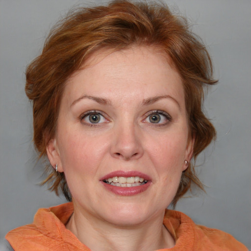 Joyful white adult female with medium  brown hair and blue eyes