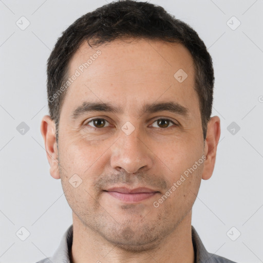 Joyful white adult male with short  brown hair and brown eyes