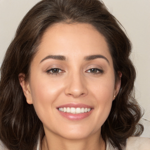 Joyful white young-adult female with medium  brown hair and brown eyes