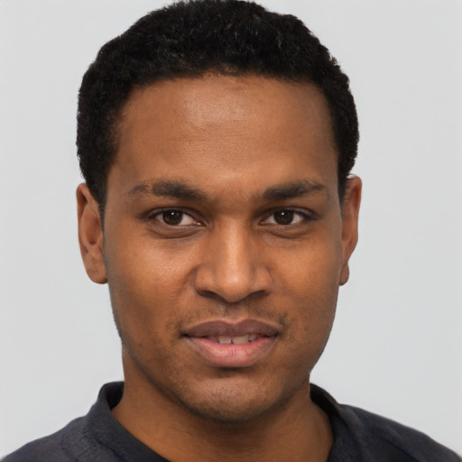 Joyful black young-adult male with short  black hair and brown eyes