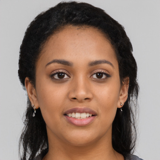 Joyful latino young-adult female with long  black hair and brown eyes