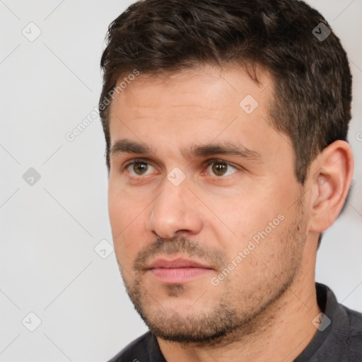 Joyful white adult male with short  brown hair and brown eyes