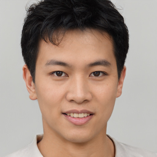 Joyful asian young-adult male with short  black hair and brown eyes