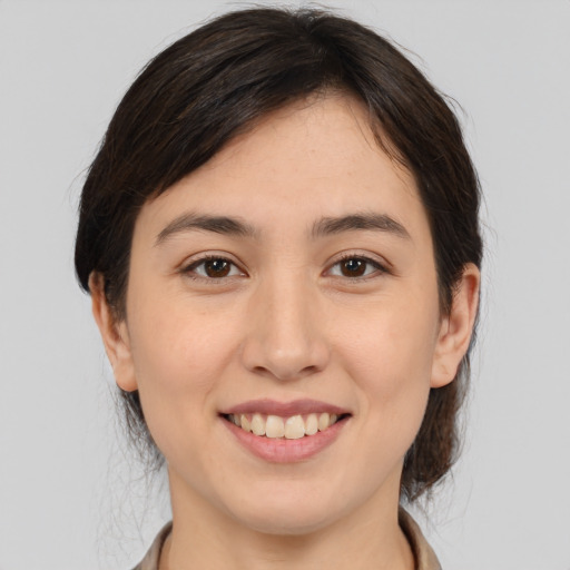 Joyful white young-adult female with medium  brown hair and brown eyes