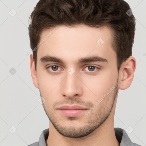 Neutral white young-adult male with short  brown hair and brown eyes