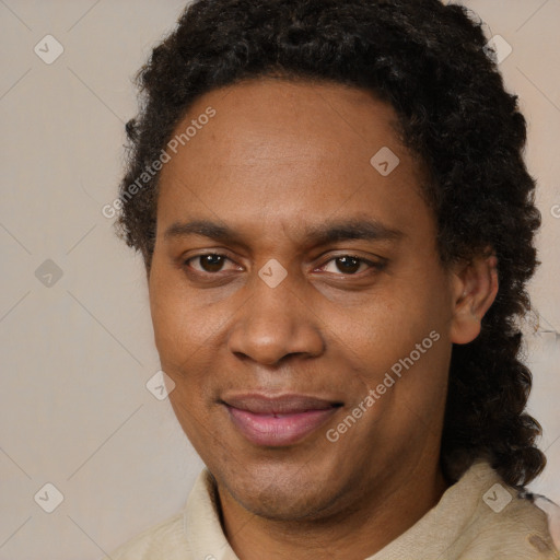 Joyful black adult male with short  brown hair and brown eyes