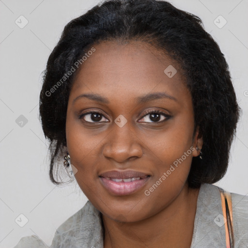 Joyful black young-adult female with long  black hair and brown eyes