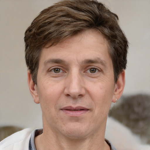 Joyful white adult male with short  brown hair and grey eyes