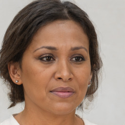 Joyful black adult female with medium  brown hair and brown eyes