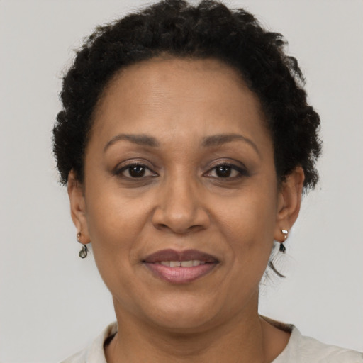 Joyful black adult female with short  brown hair and brown eyes