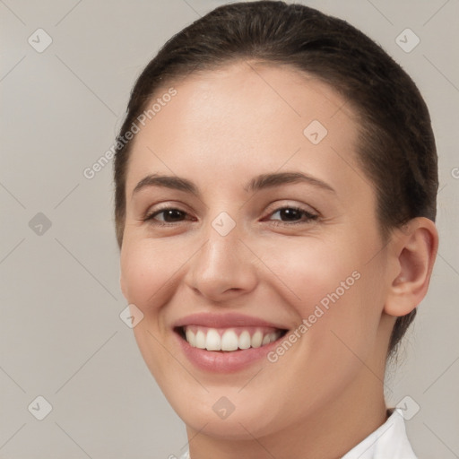 Joyful white young-adult female with short  brown hair and brown eyes