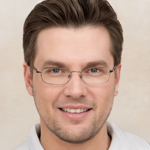 Joyful white young-adult male with short  brown hair and grey eyes