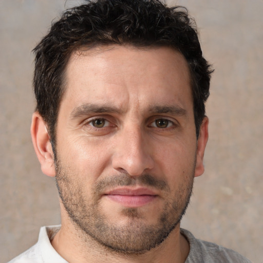 Joyful white adult male with short  brown hair and brown eyes