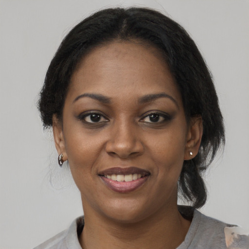 Joyful black young-adult female with medium  black hair and brown eyes