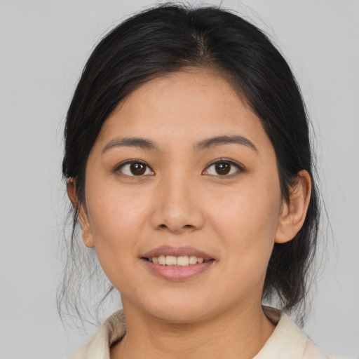 Joyful asian young-adult female with medium  brown hair and brown eyes