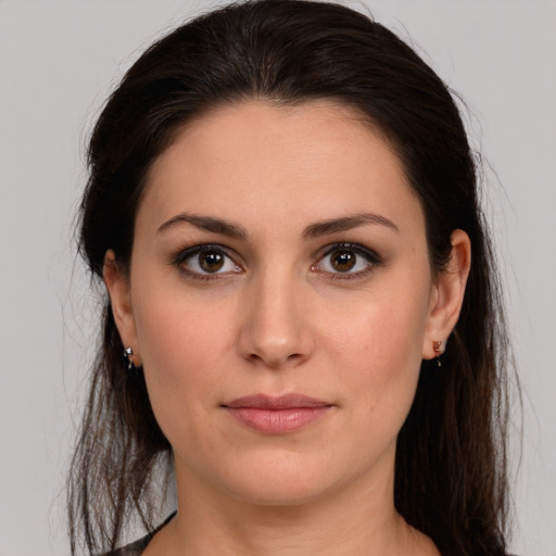 Joyful white young-adult female with long  brown hair and brown eyes