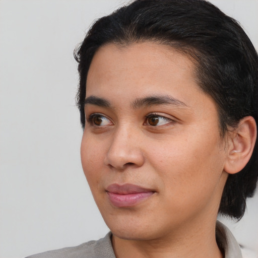 Joyful white young-adult female with short  brown hair and brown eyes