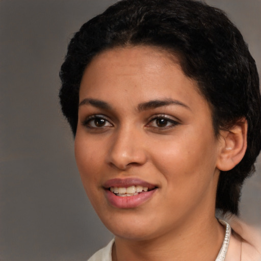 Joyful latino young-adult female with short  black hair and brown eyes