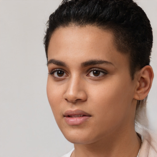 Joyful latino young-adult female with short  brown hair and brown eyes