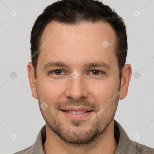 Joyful white young-adult male with short  brown hair and grey eyes