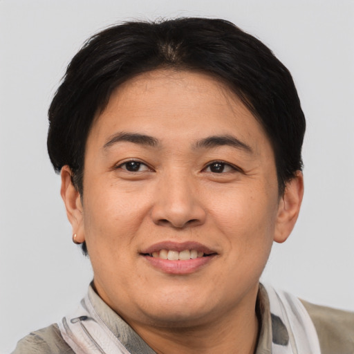Joyful asian adult female with short  brown hair and brown eyes
