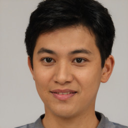 Joyful asian young-adult male with short  brown hair and brown eyes