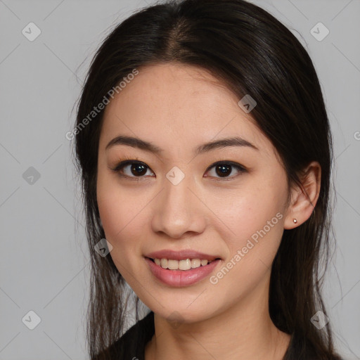 Joyful asian young-adult female with long  brown hair and brown eyes