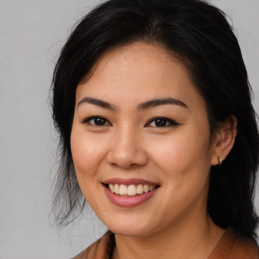 Joyful asian young-adult female with long  black hair and brown eyes